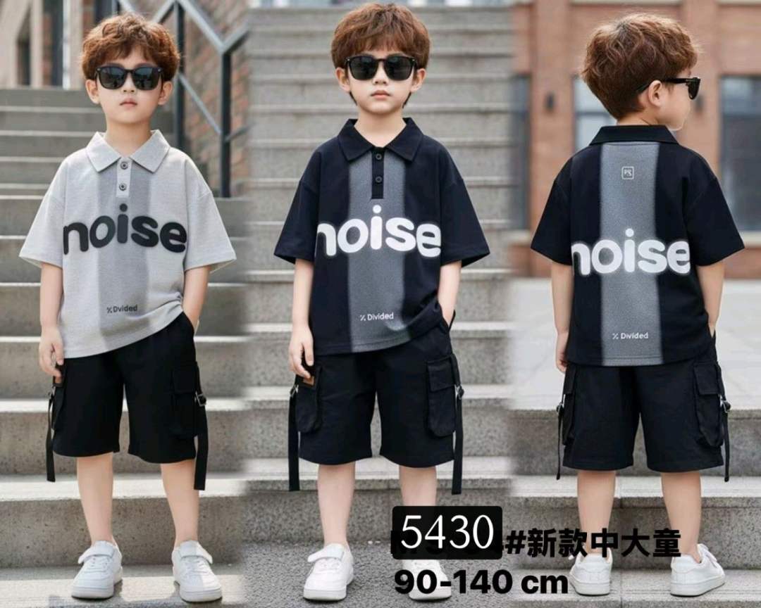 Three children wearing matching outfits with 'noise' branding on a staircase.
