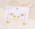 Gold jewelry set with butterfly and heart designs on a white card labeled 'Jewelry'.