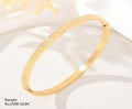 Gold bangle on a white background