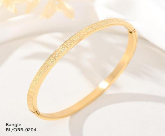 Gold bangle on a white background