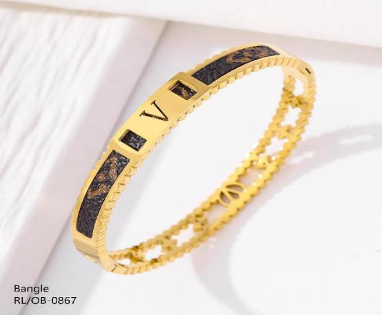 Gold bracelet with black stones on a white background