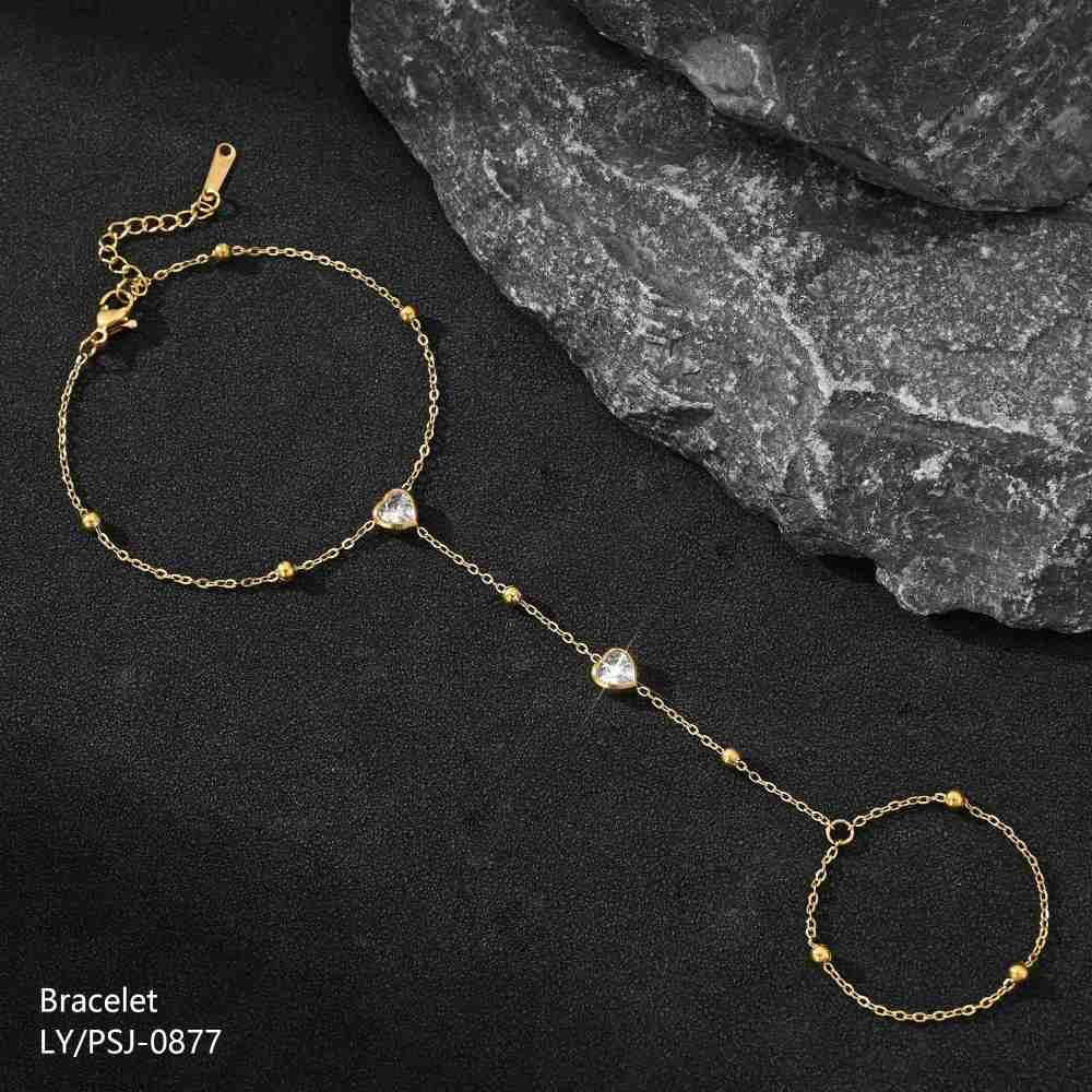 Gold bracelet with heart-shaped beads on a dark surface