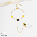Gold bracelet with black and yellow accents on a white background
