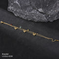 Gold bracelet with bow-shaped charms on a dark surface