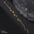 Gold bracelet with decorative charms on a dark surface