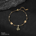 Gold bracelet with butterfly charms on a dark surface
