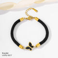 Black braided bracelet with gold accents and a butterfly charm on a white background