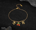 Gold bracelet with colorful charms on a dark background