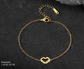 Gold bracelet with a heart-shaped clasp on a dark surface