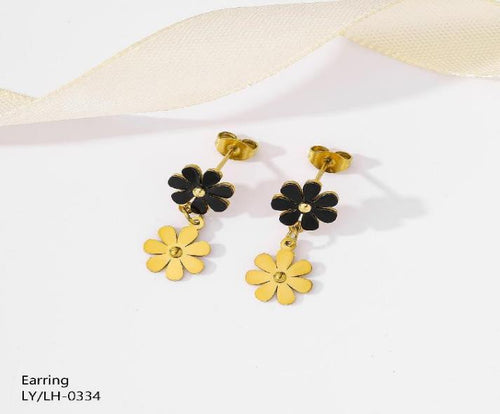 Gold and black floral earrings on a white background