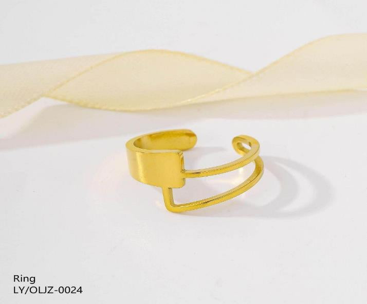 Gold ring on a white background with a soft yellow ribbon