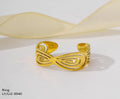 Gold ring with intricate design on a white background