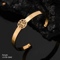 Gold bangle with intricate design on a dark background