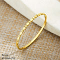 Gold bangle on a woven mat